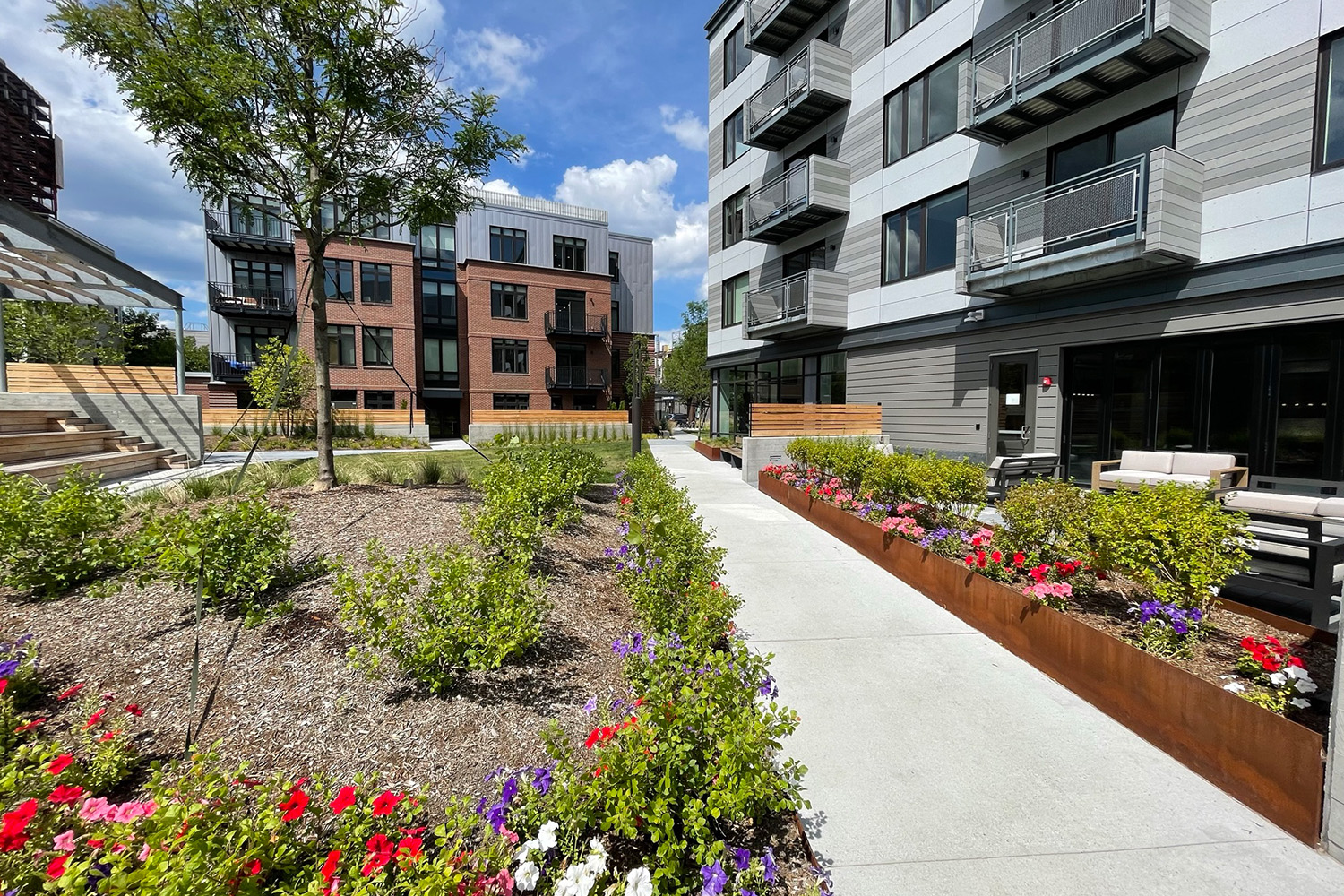 Walkway next to outdoor amenity space at Flats on First