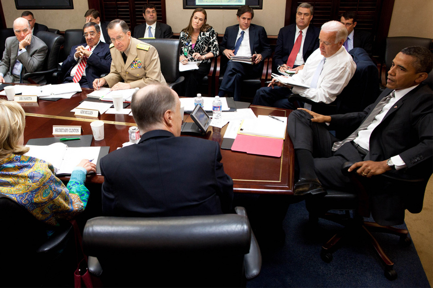 Barack Obama, Joe Biden, Hilary Clinton, and several other government officials sitting at table in situation room 