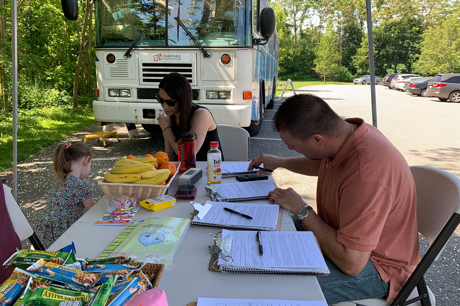 Angelo Syrniotis fills out paperwork before donating blood at TOCCI blood drive