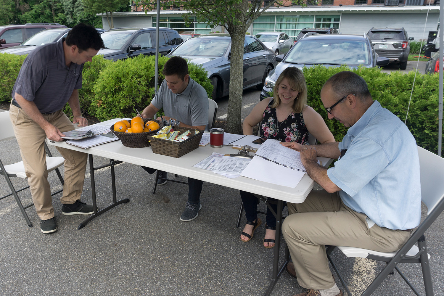 TOCCI staff sit down filling out forms before donating blood in 2018