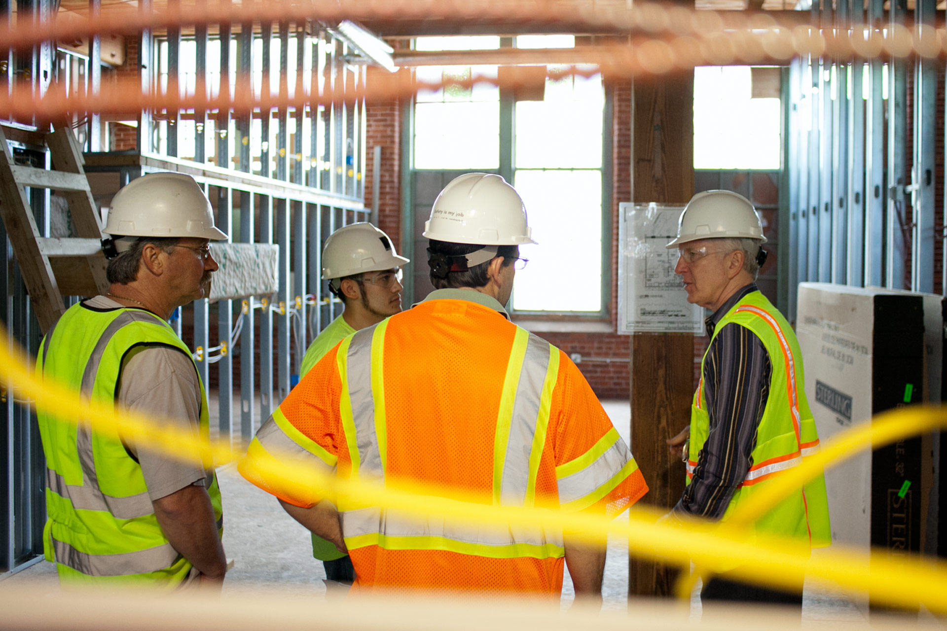 John Tocci amongst other Tocci employees, as they wear PPE, and in discussion 