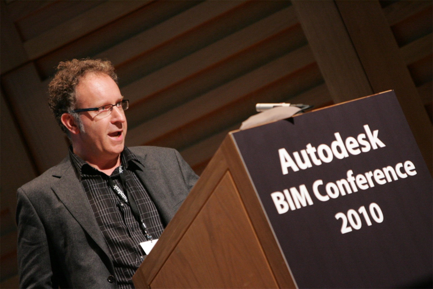 man speaking behind podium at 2010 BIM conference in London 