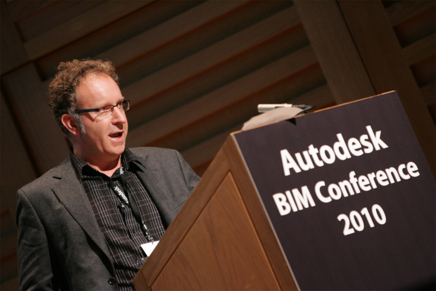 man speaking behind podium at 2010 BIM conference in London