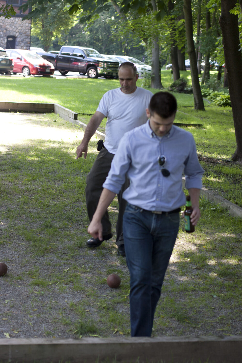 2 Tocci employee standing in bocce ball pit