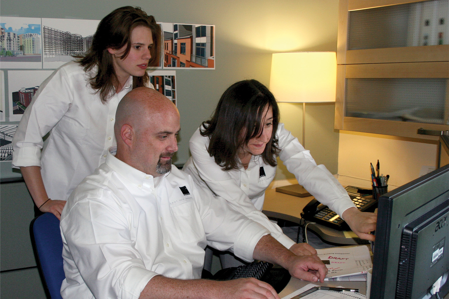 Tocci's VDC team members at work by a computer 