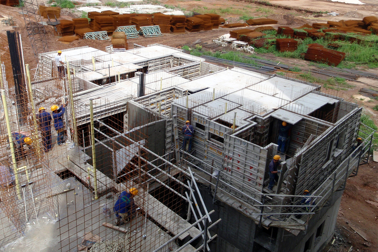 construction workers installing concrete walls in building