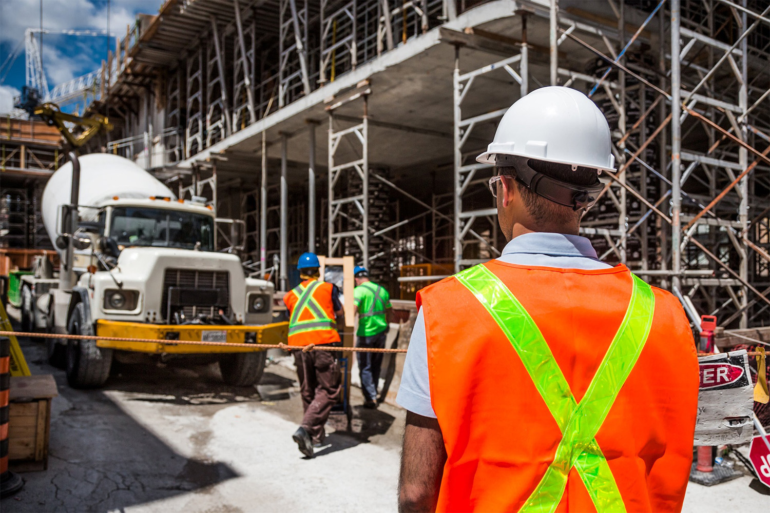 two construction workers wearing safety vests and hard hats 