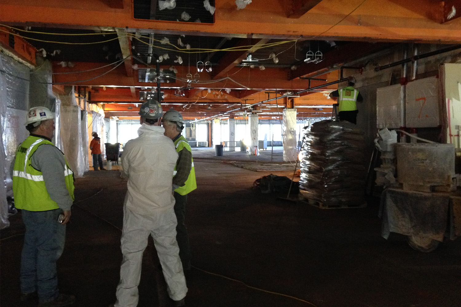 construction at Rodino building - Tocci employees discuss while wearing PPE 