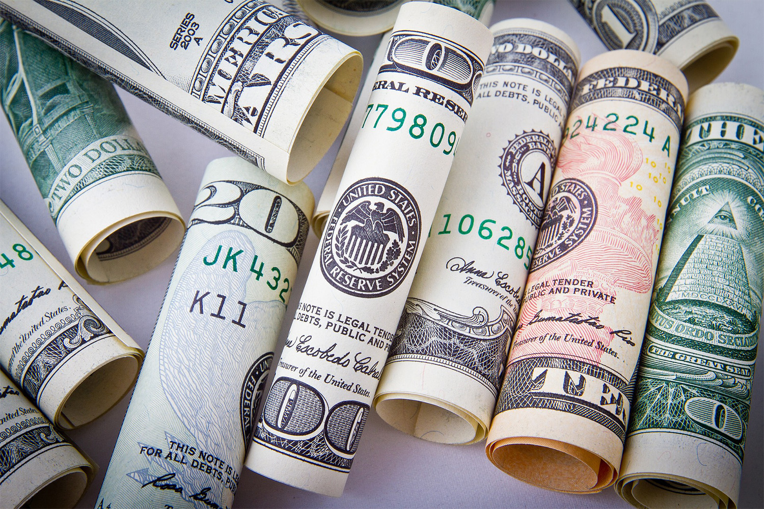 assorted U.S. dollar bills, rolled up