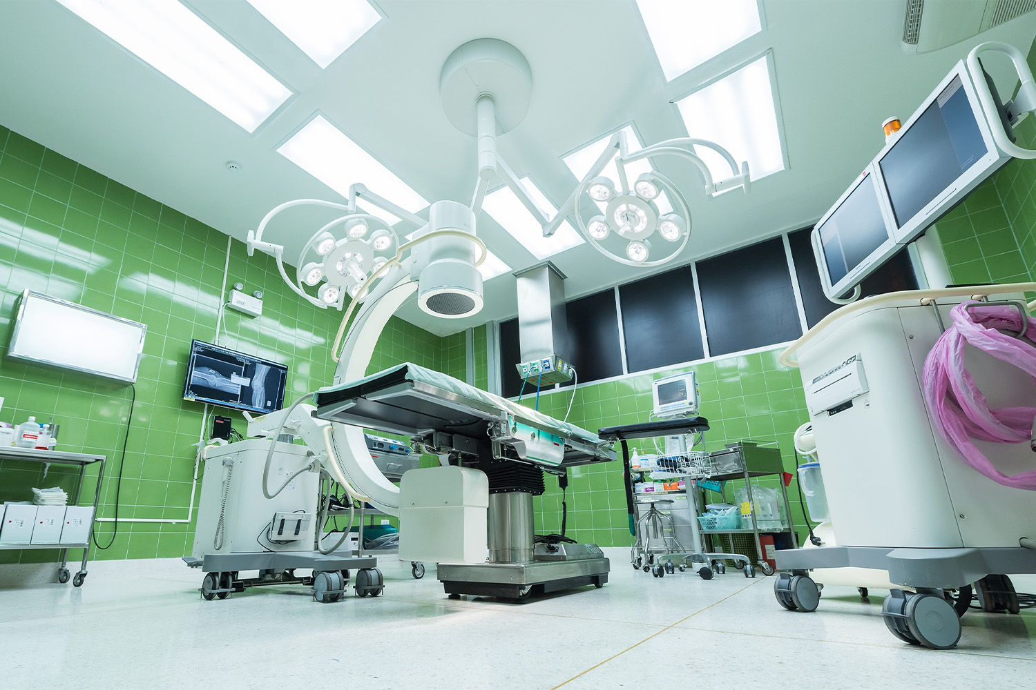hospital examination room with green walls and light fixtures