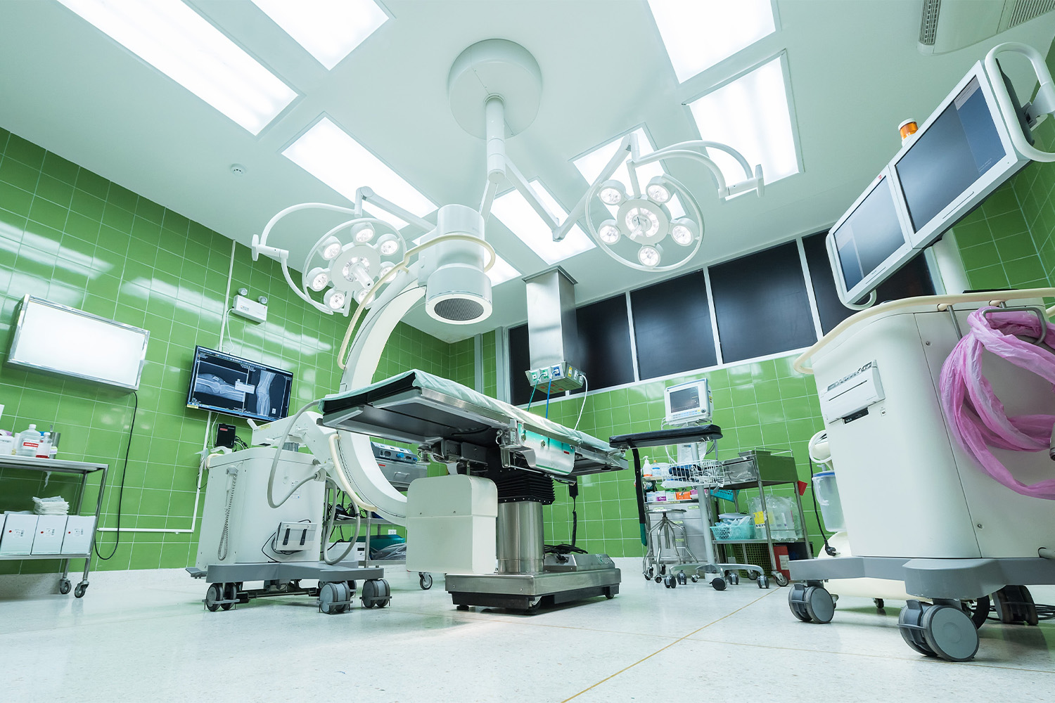 hospital examination room with green walls and light fixtures 