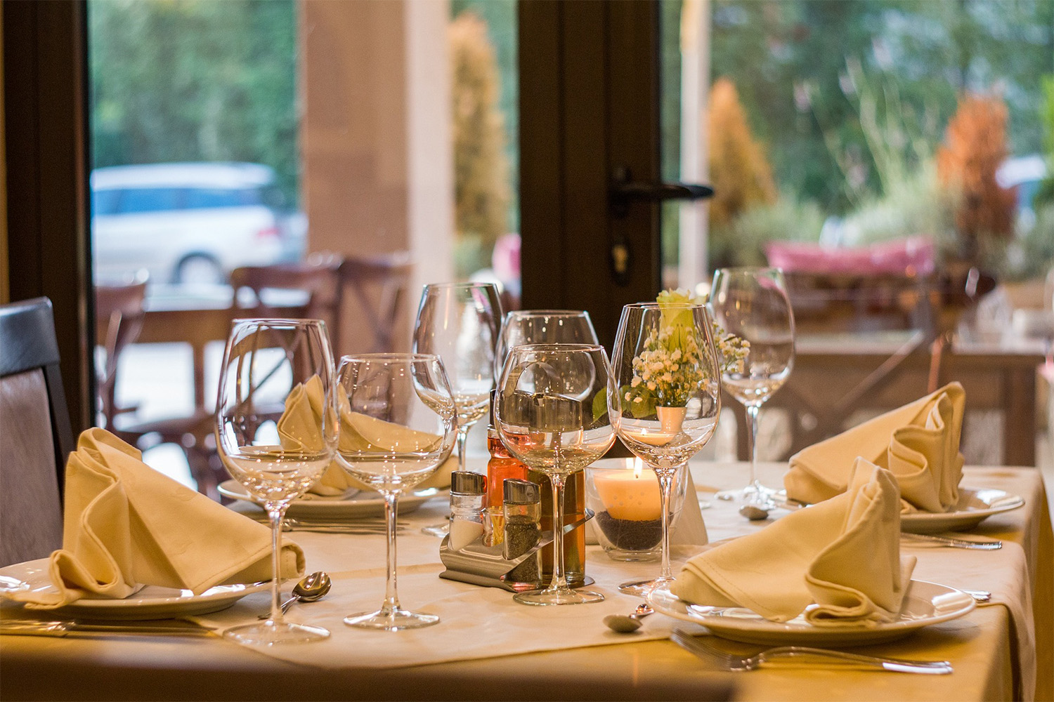 dinner table with plates and wine glasses 