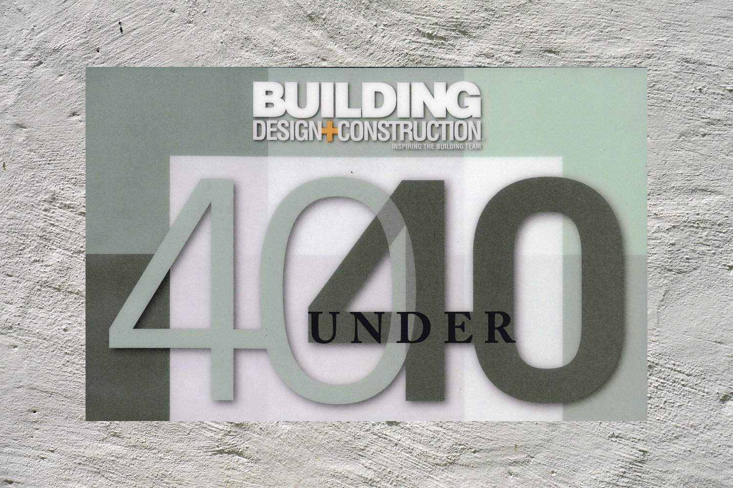 plaster background with logo of Building & Design Construction 40 Under 40 logo 