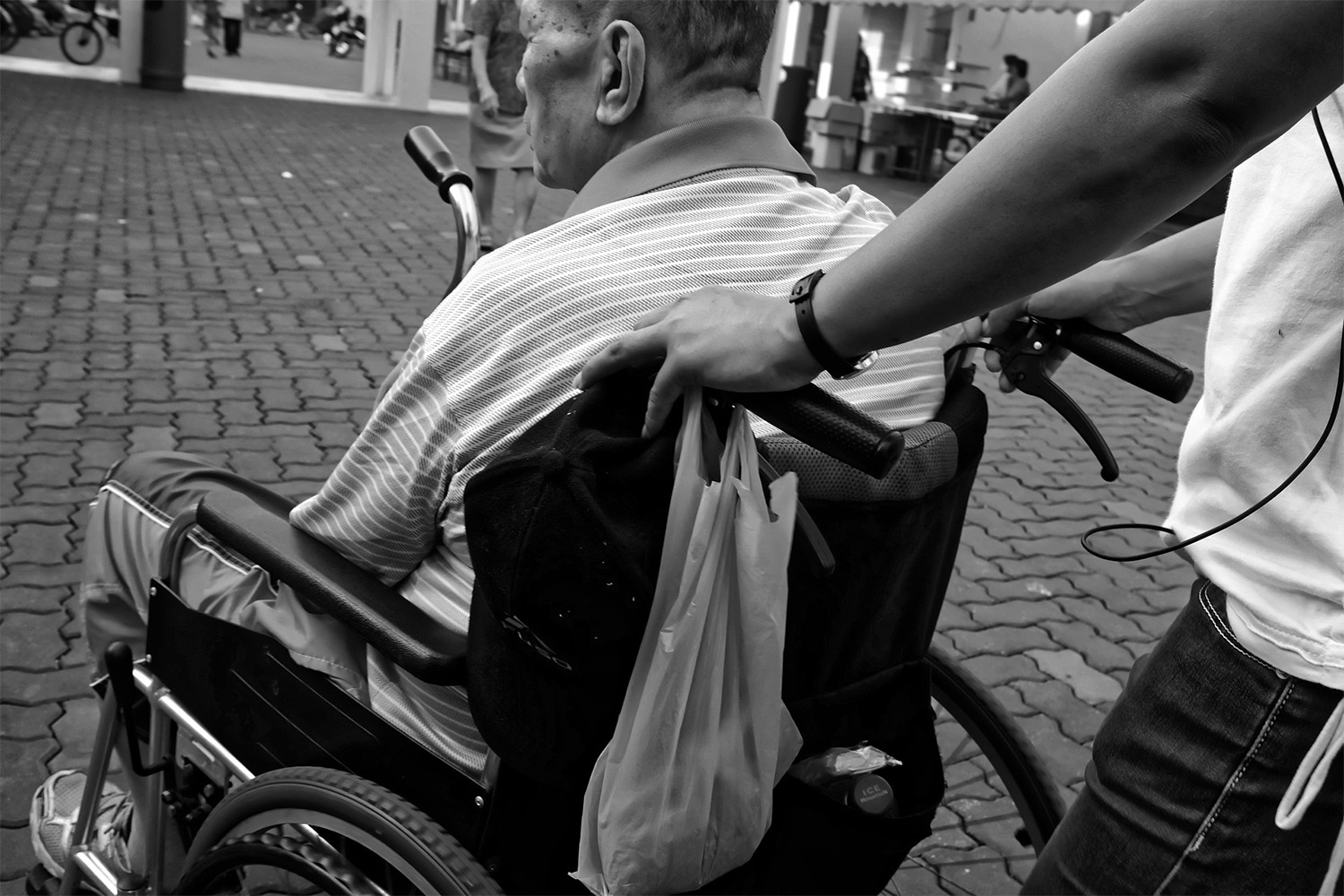 black and white picture of an old man in a wheelchair 