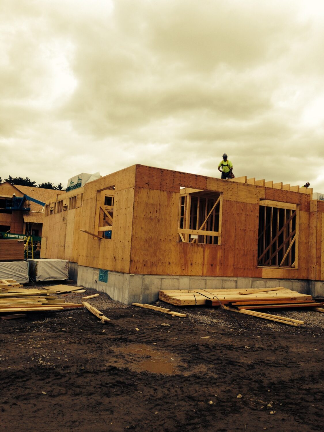 A worker properly spaces and secures the trusses