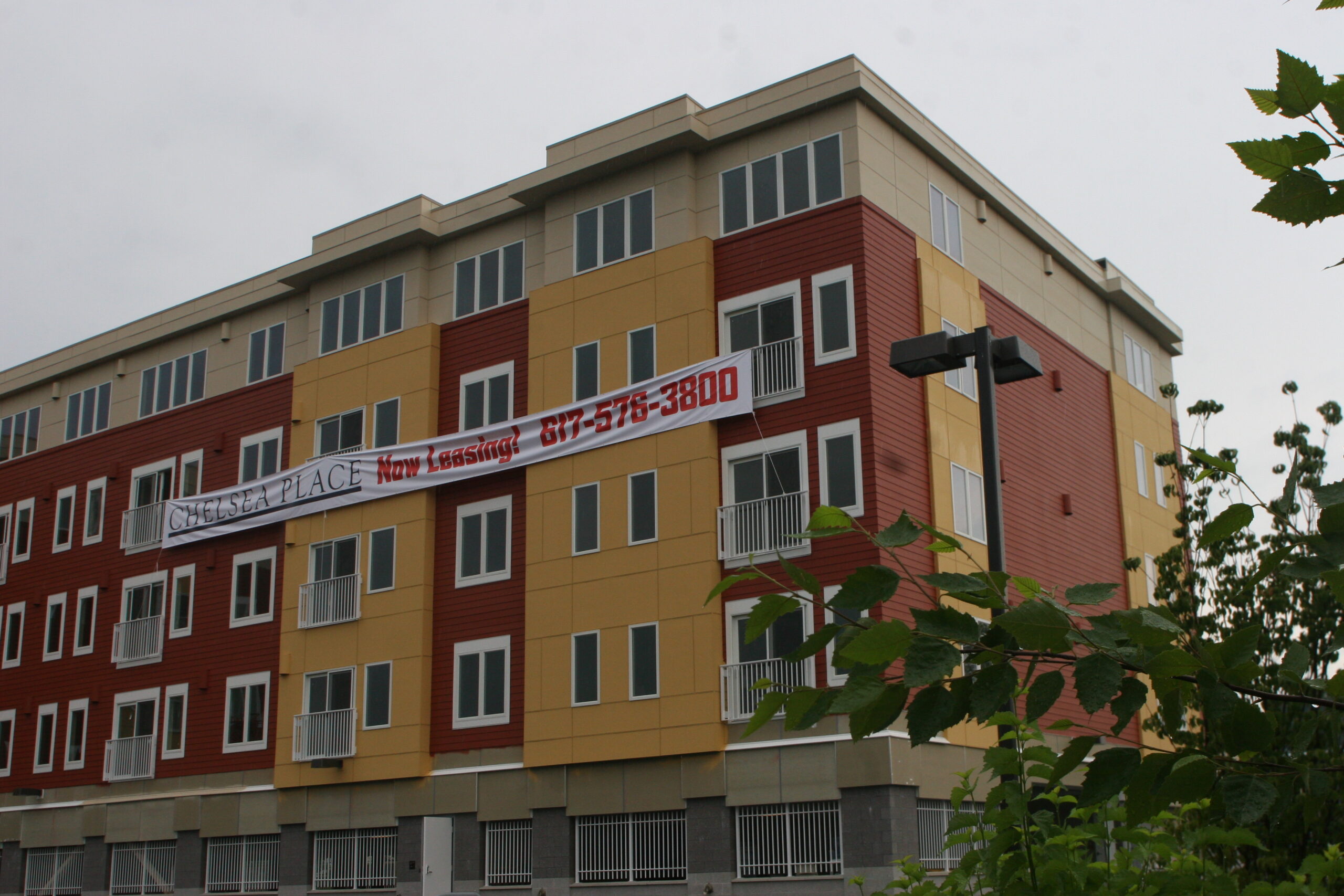 Chelsea Place with a sign saying "NOW LEASING"