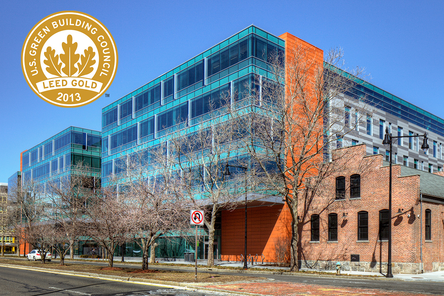 Distanced view of 225 Binney building, with LEED Gold logo on the upper left hand side