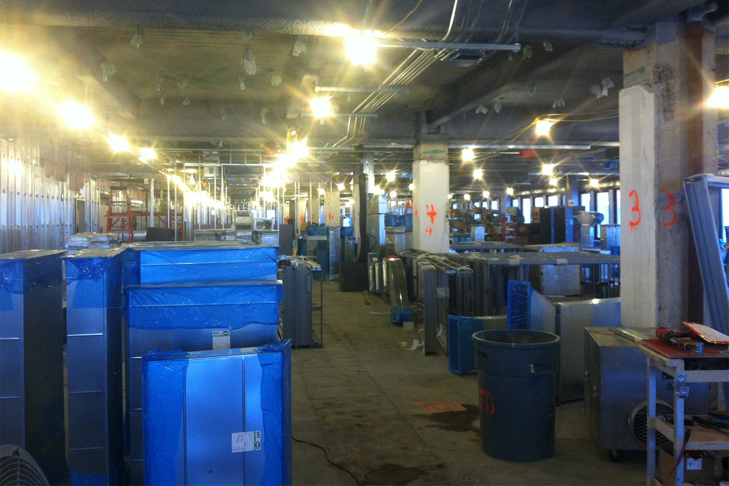 view of work on the 13th floor - concrete beams and blue boxes 