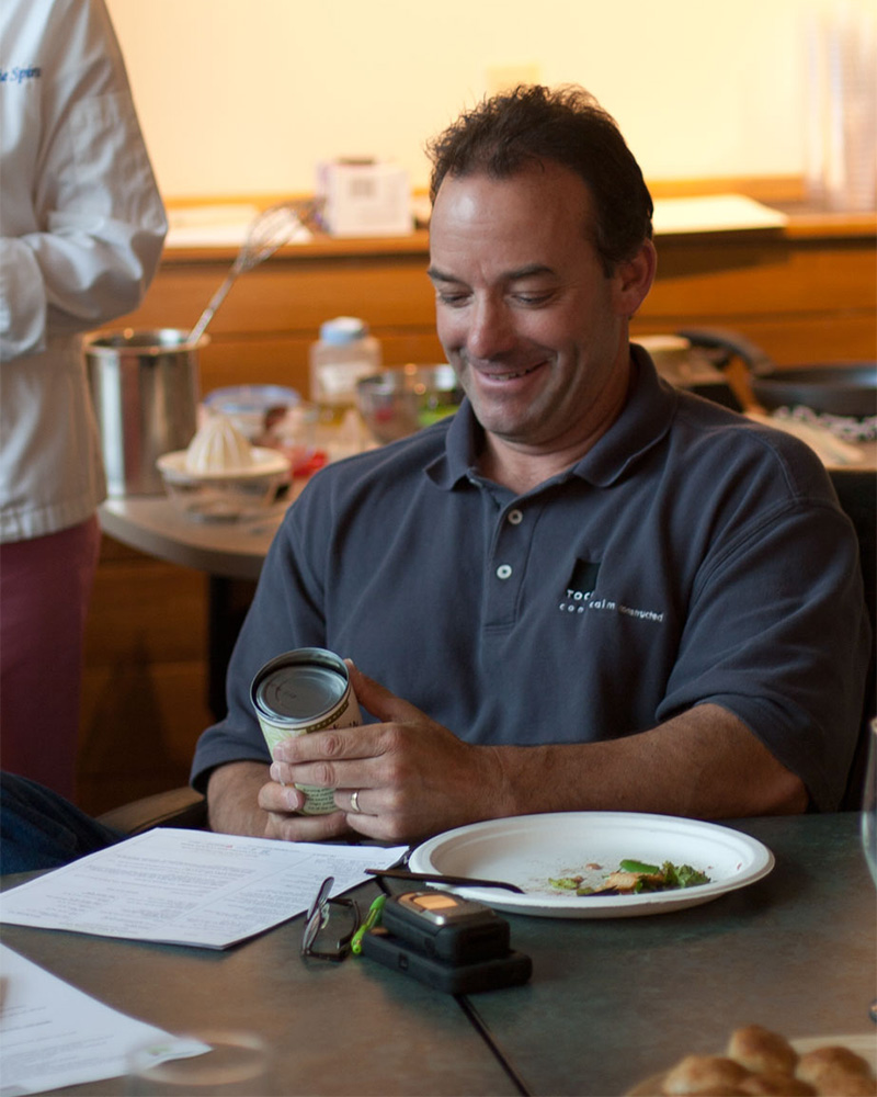 Bob Tierney, Tocci’s General Superintendent, reads the chick pea nutrition label to assess sodium content