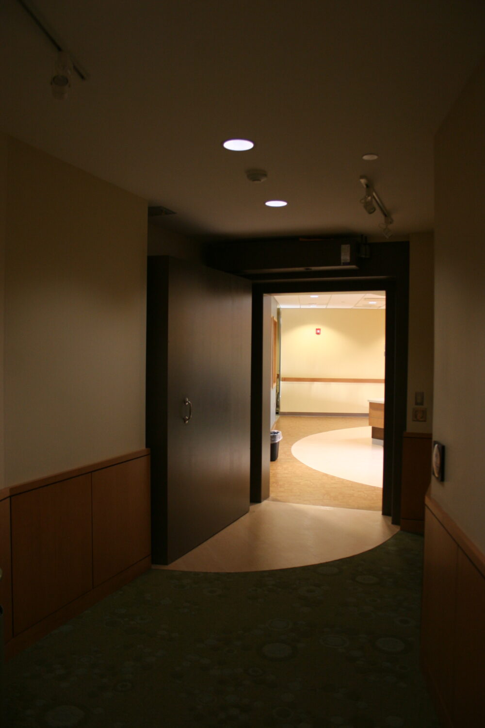 dark hallway leading to open door 