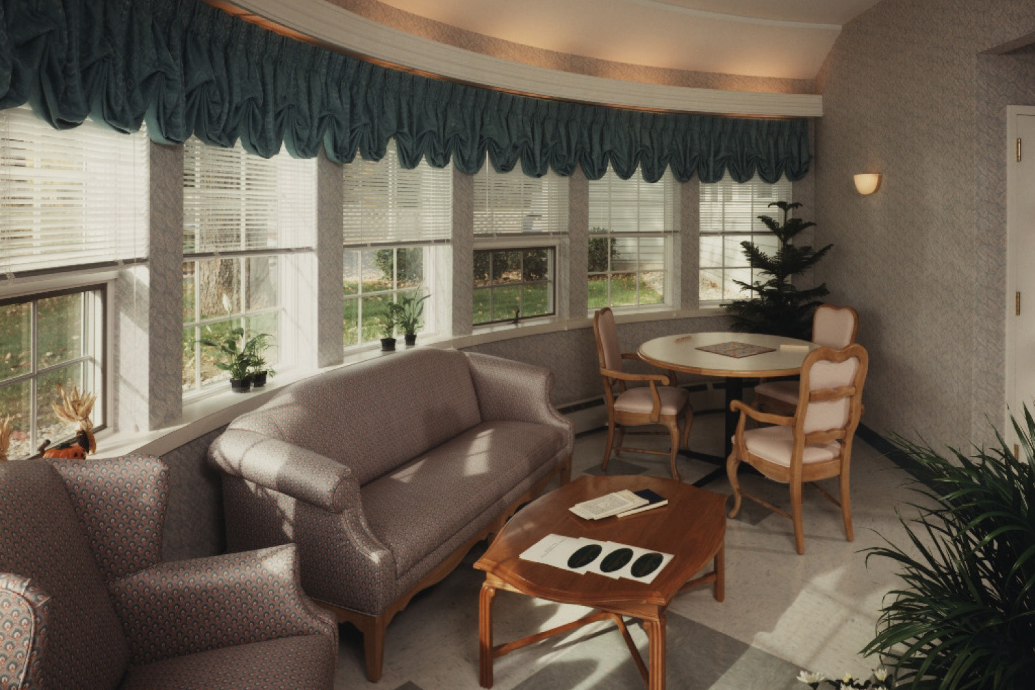 Living room with tan couches in front of panoramic large windows