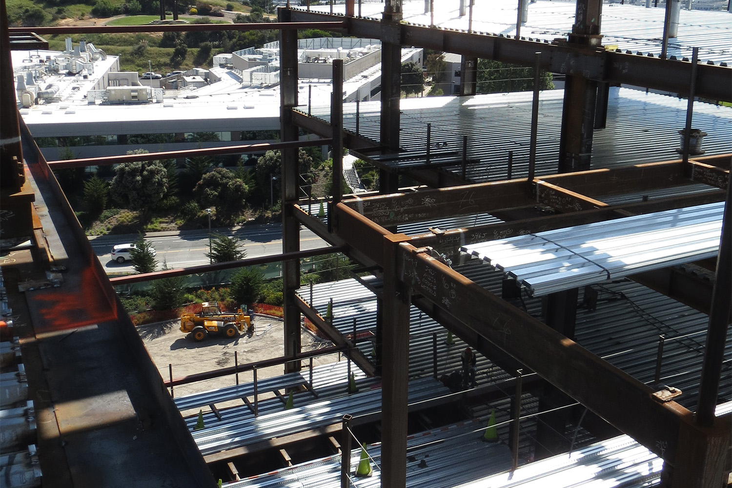 parking garage under construction, with the sun shining on it 