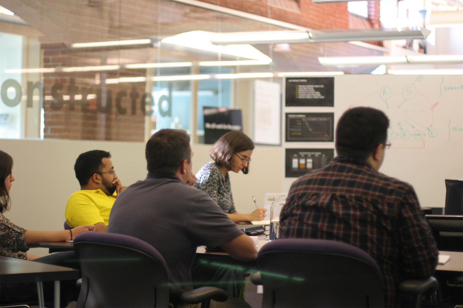 People taking notes while learning about BIM at Tocci's Collocation center 