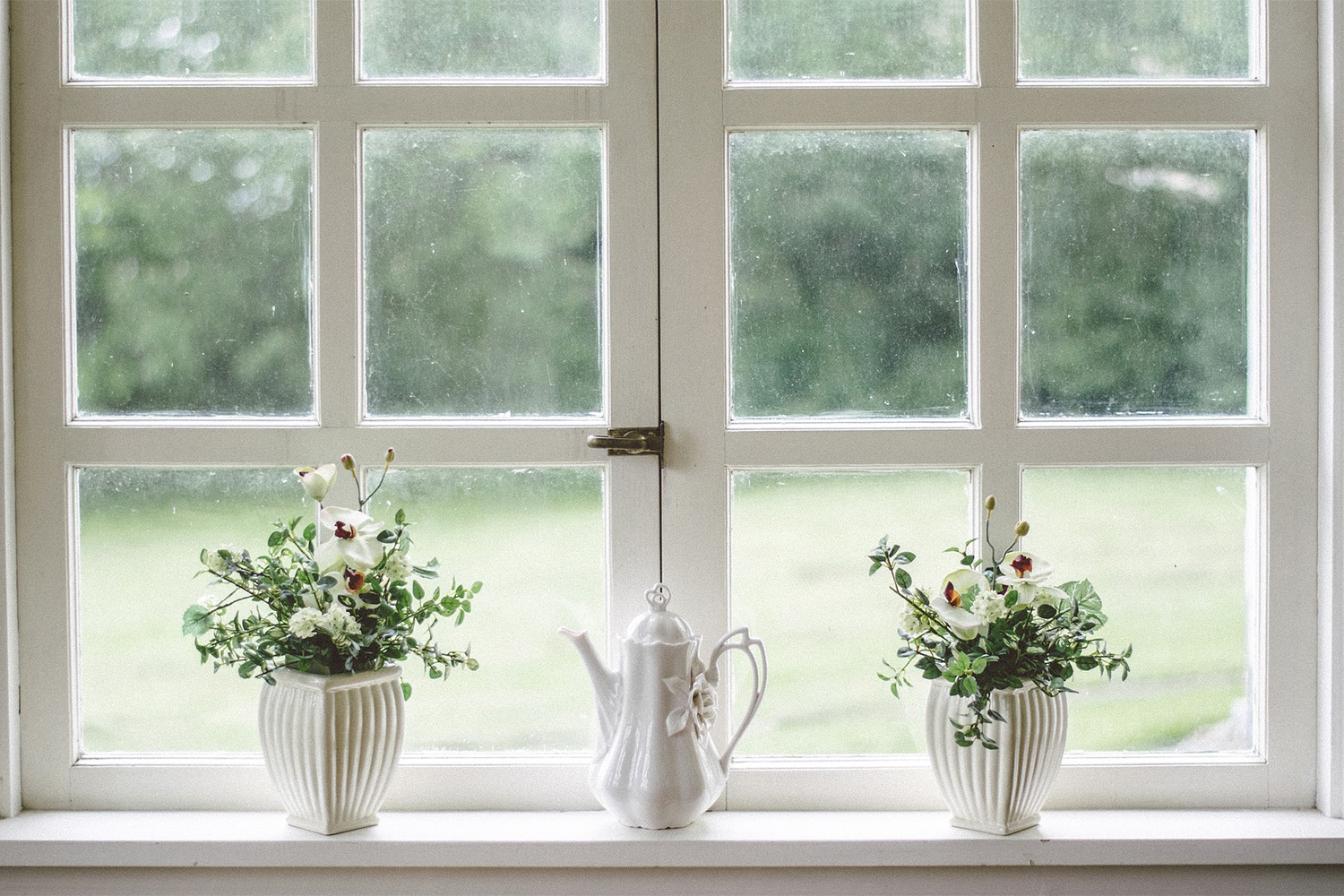 window with white panes, and potted plants on window sill