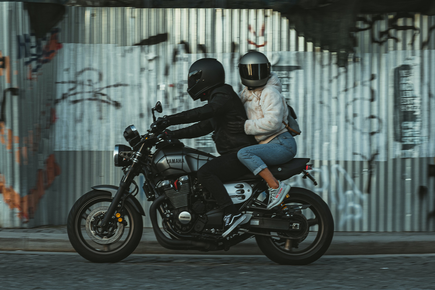 a man and women riding a motorcycle 