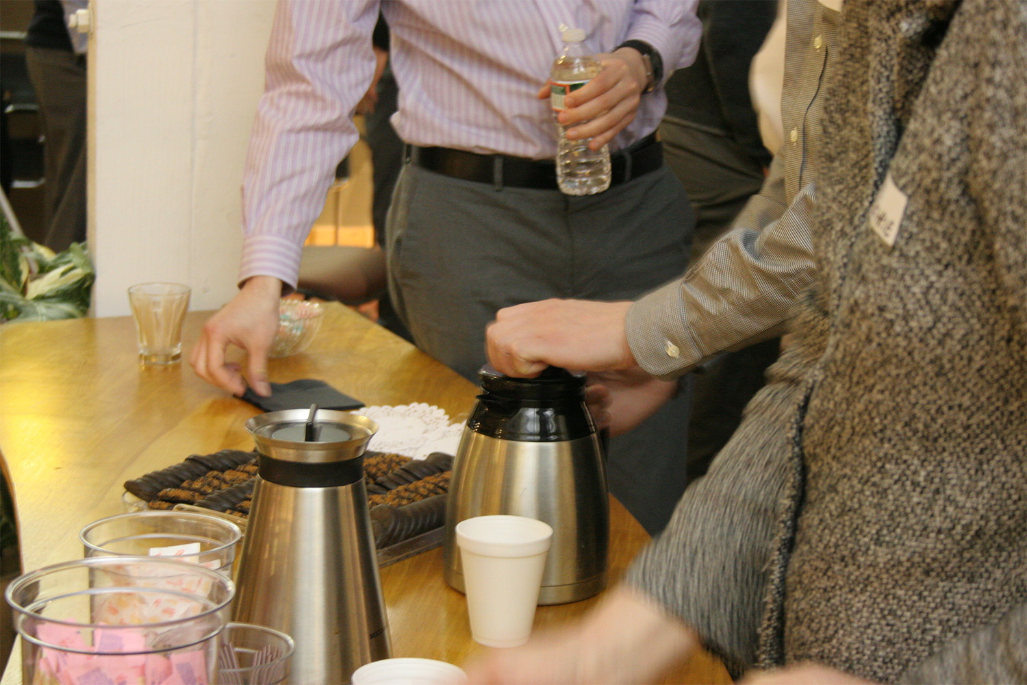 Tocci employees at coffee table making drinks 