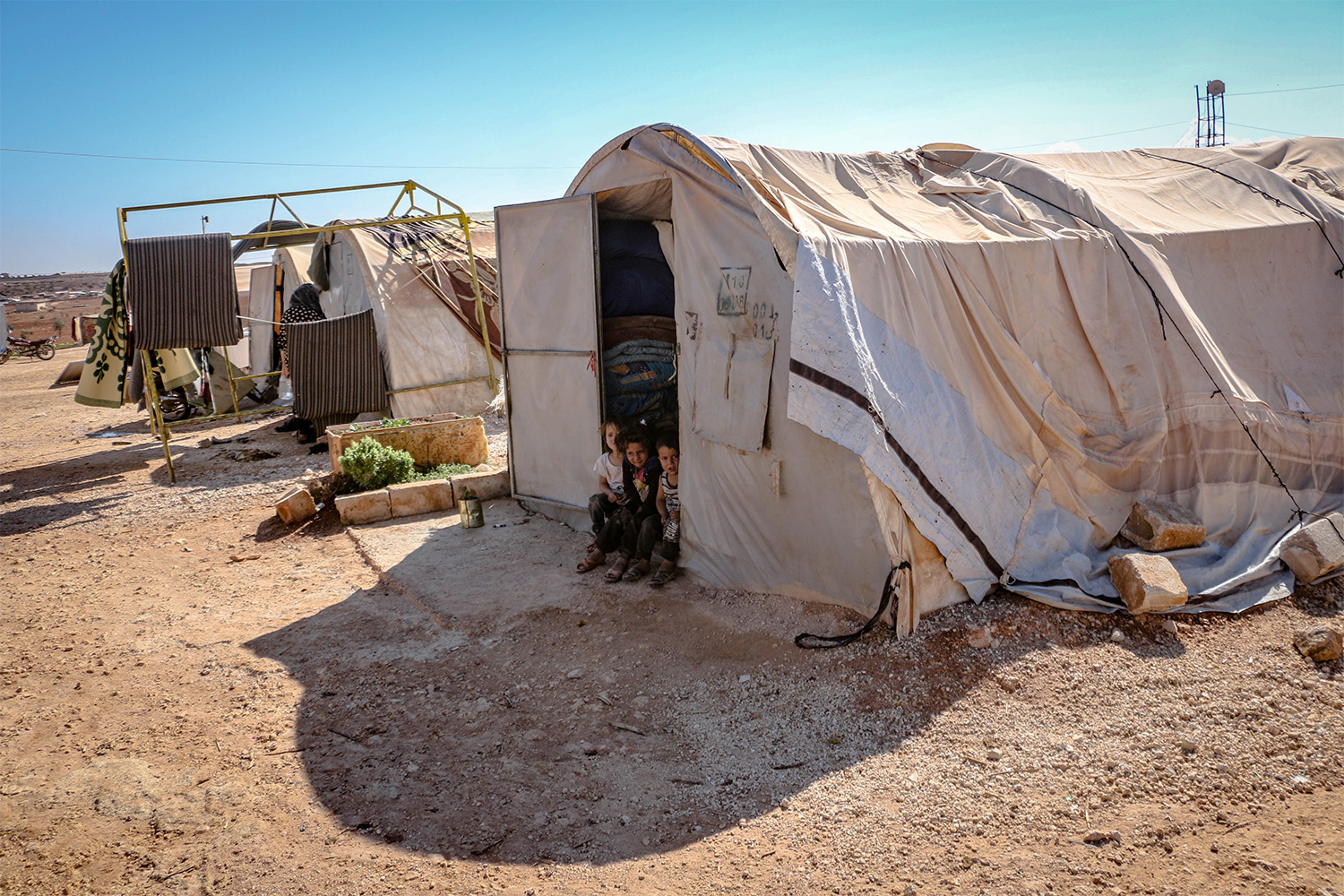 Syrian refugee children sharing a tent