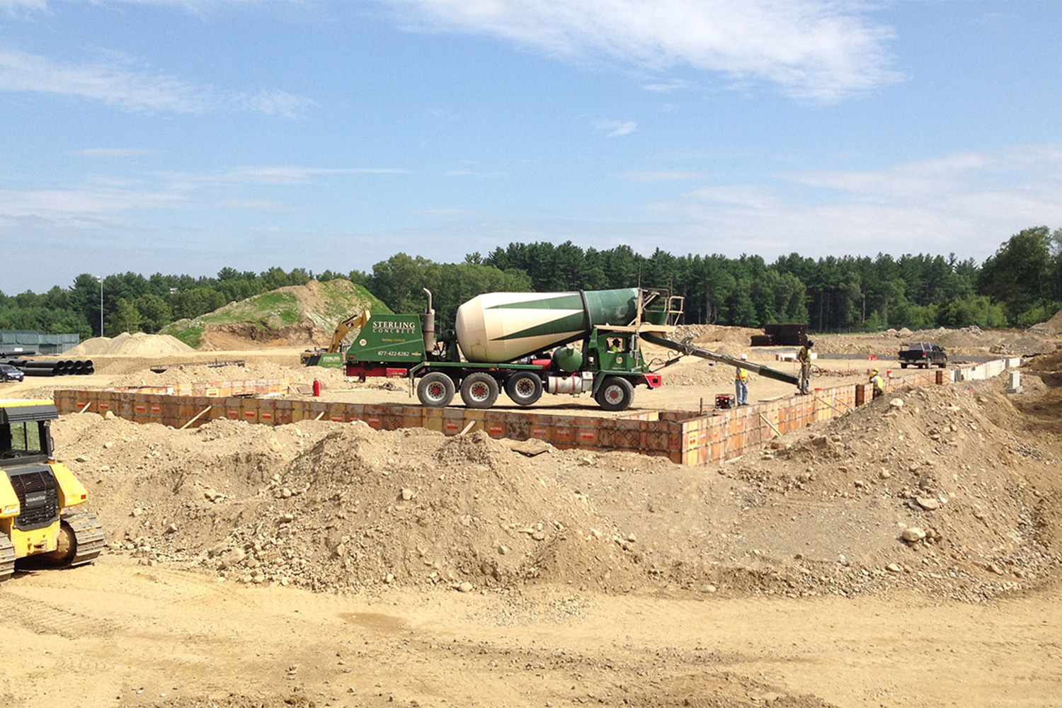cement truck on top of dirt pile at the Westborough Woods construction site