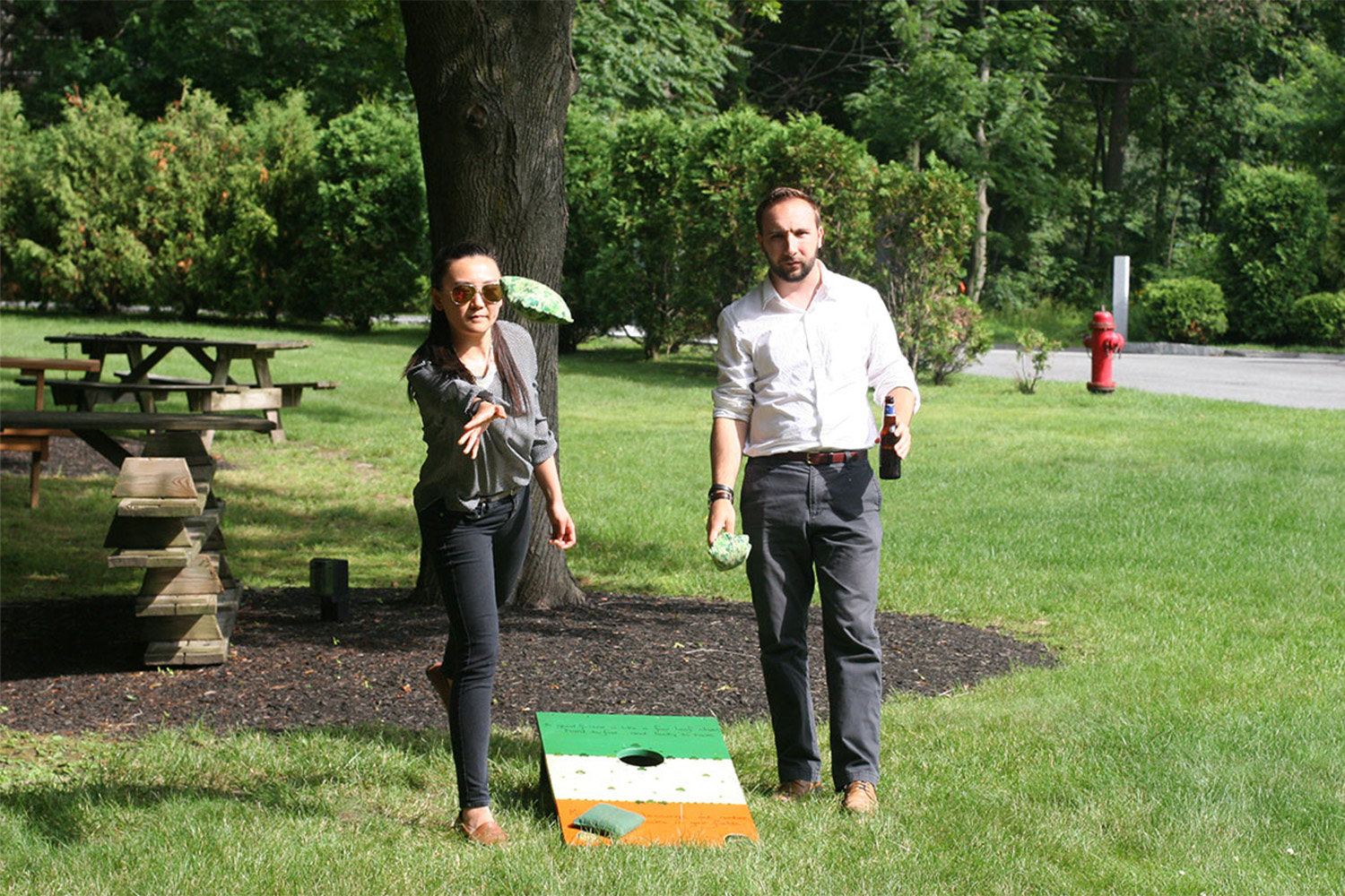 a man and a woman playing cornhole 