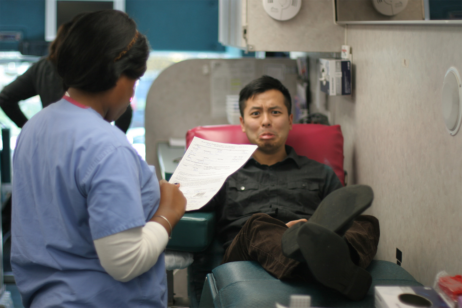 Bryan pouting as he waits his turn to get his blood drawn