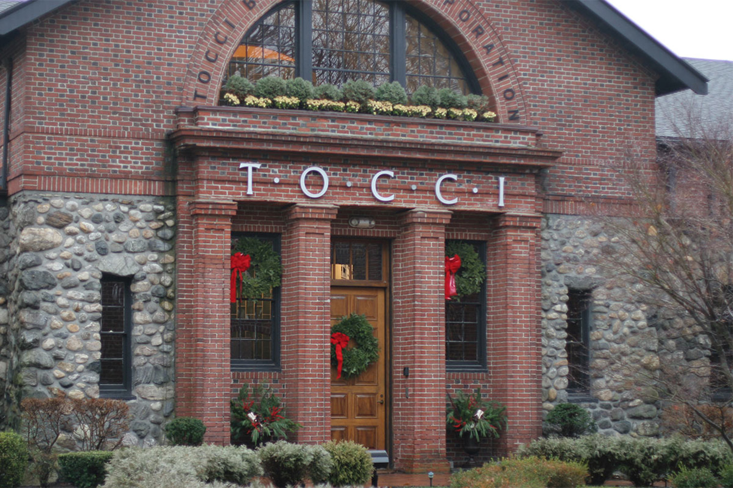 entrance to Tocci office building, with Christmas decorations above entrance door 