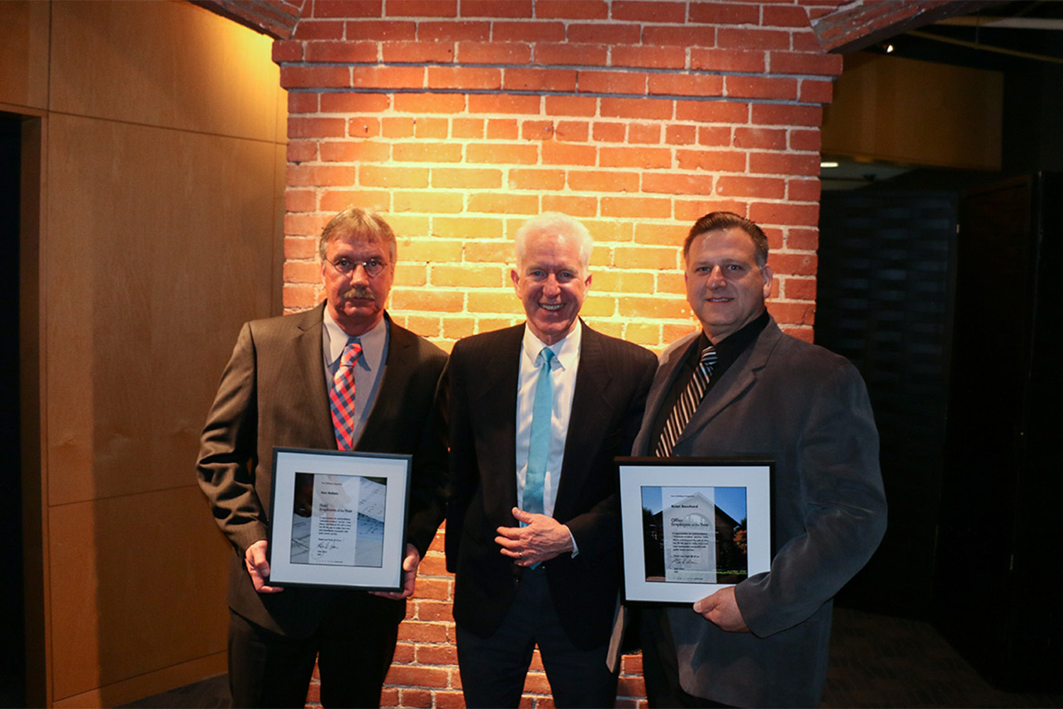 Employees of the Year, Ken + Brian, with John, receiving their rewards 