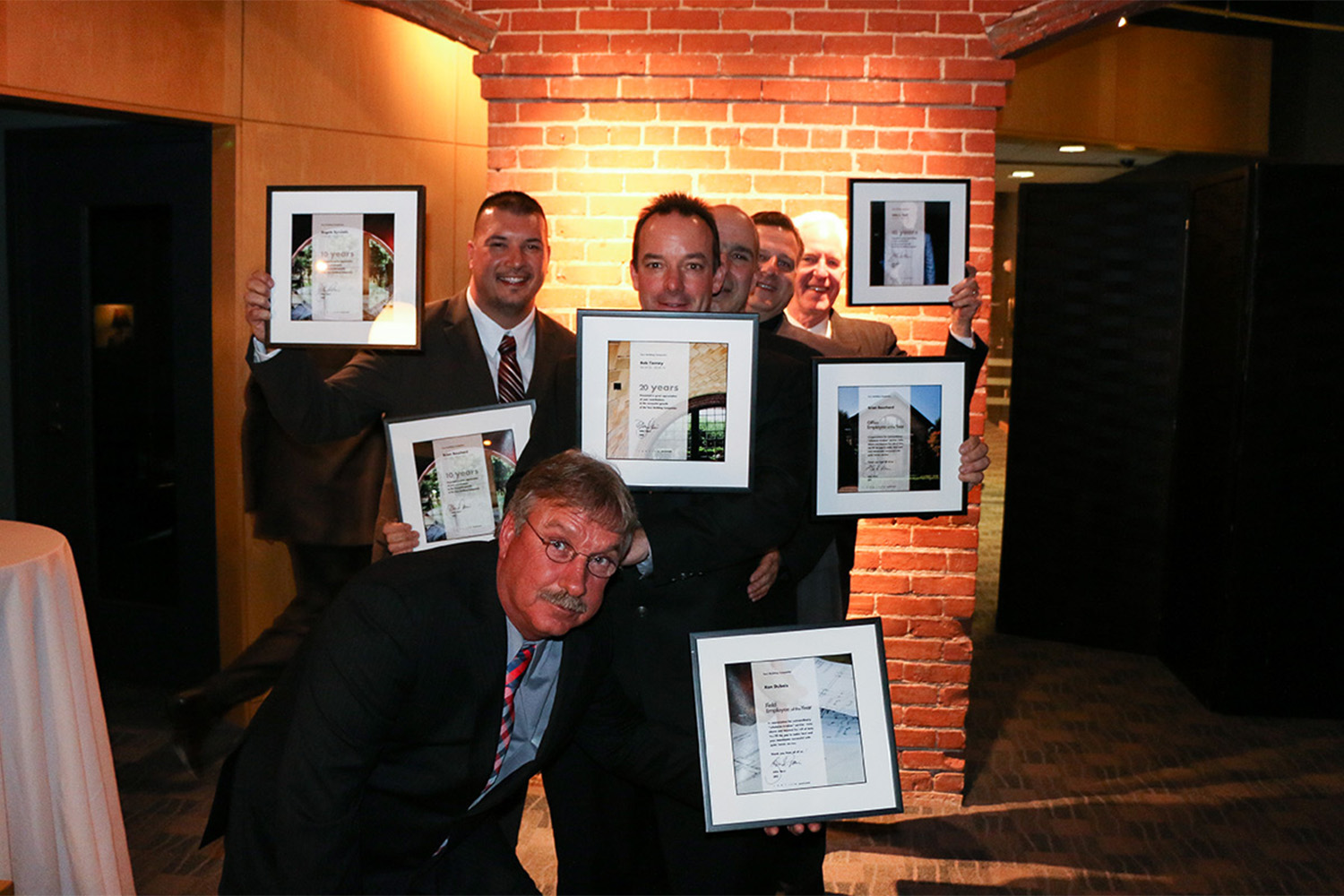 Tocci employees pose with awards for photo 