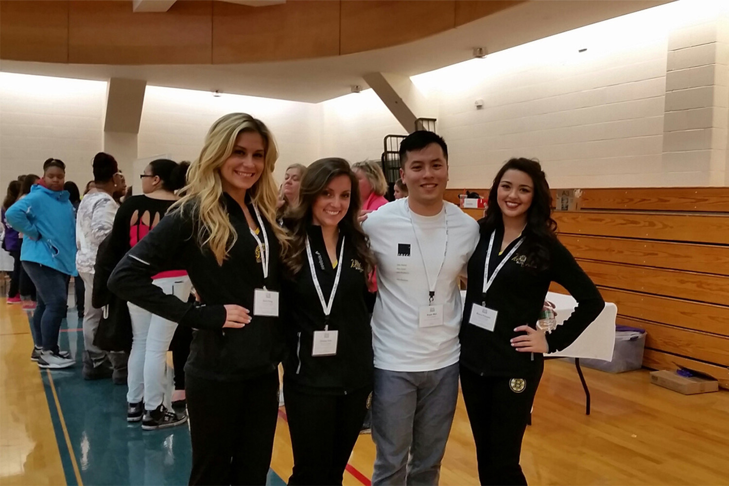 Bryan taking a photo with some of the Bruins Ice Girls who were also there volunteering