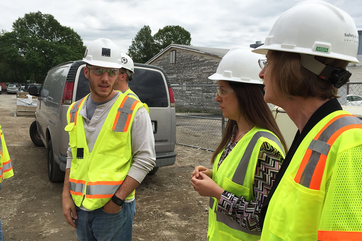 Dan talks to Vanessa and Lila about the progress on the outside of the building