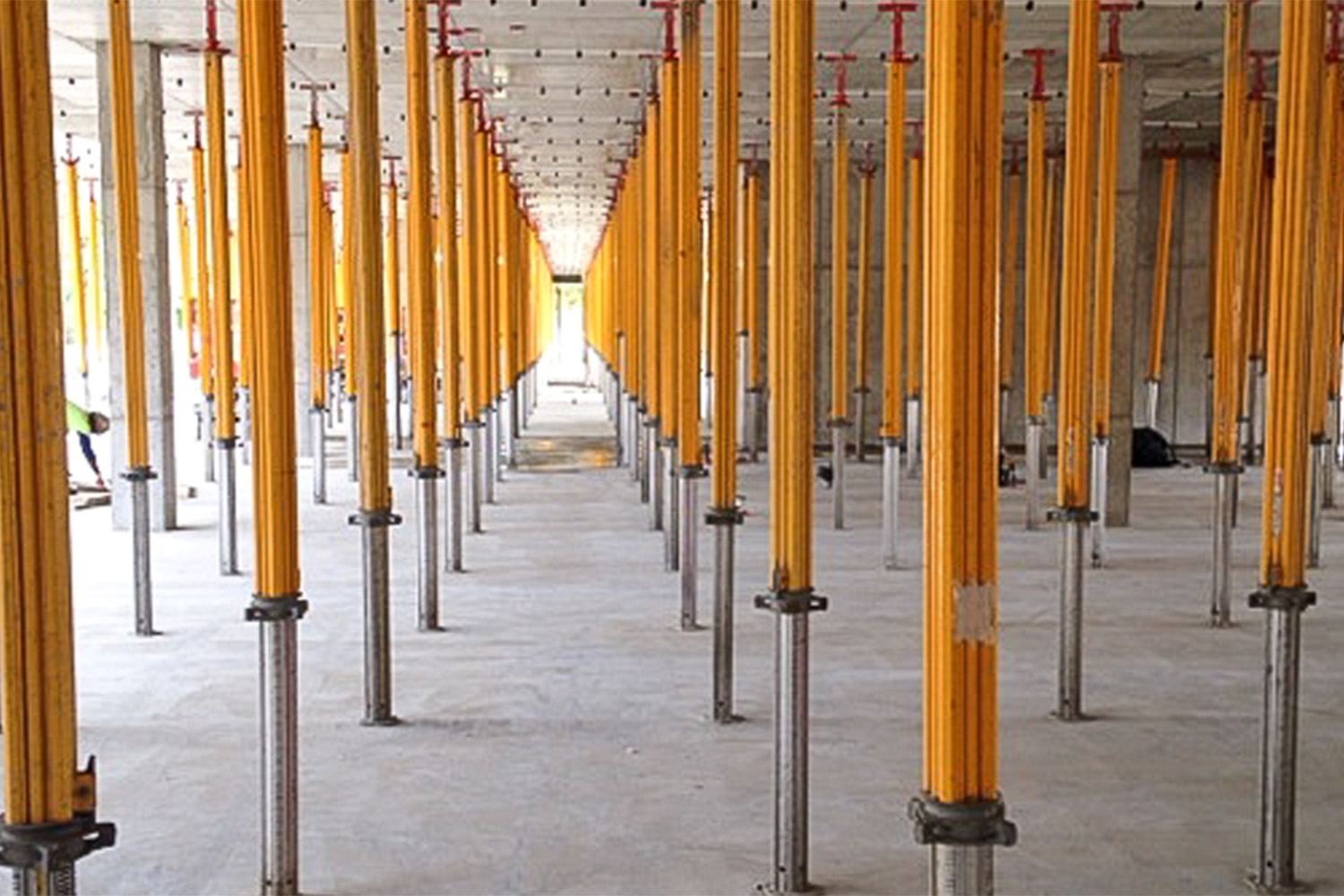 long yellow metal poles connected from ceiling to floor 