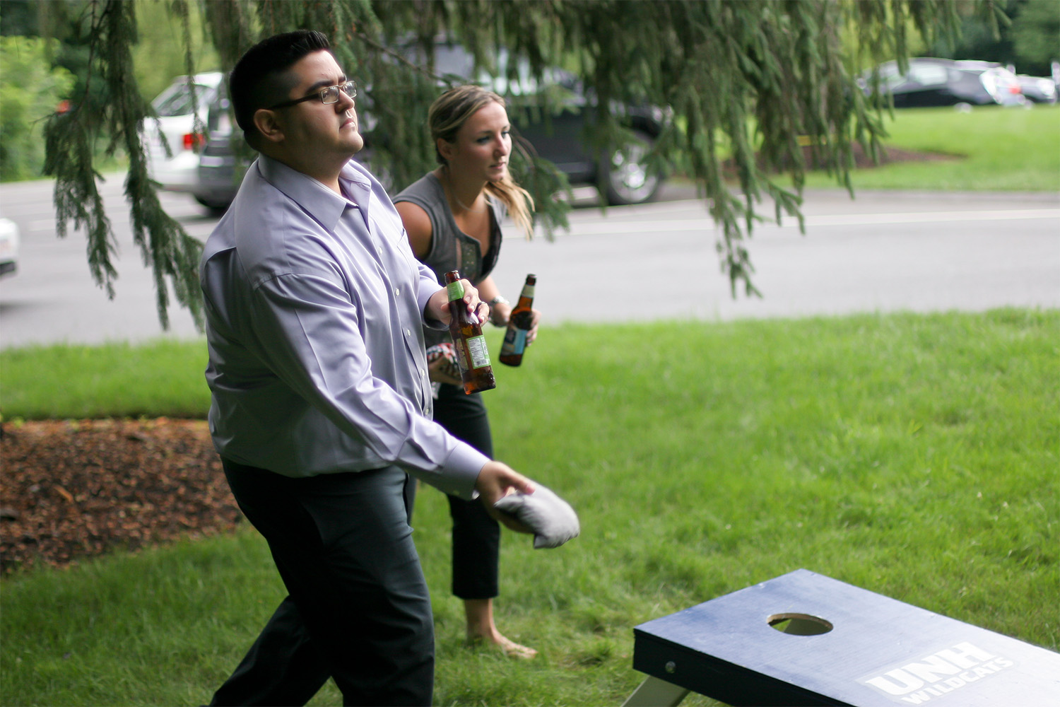Man looking ahead, preparing to throw a sack into the cornhole