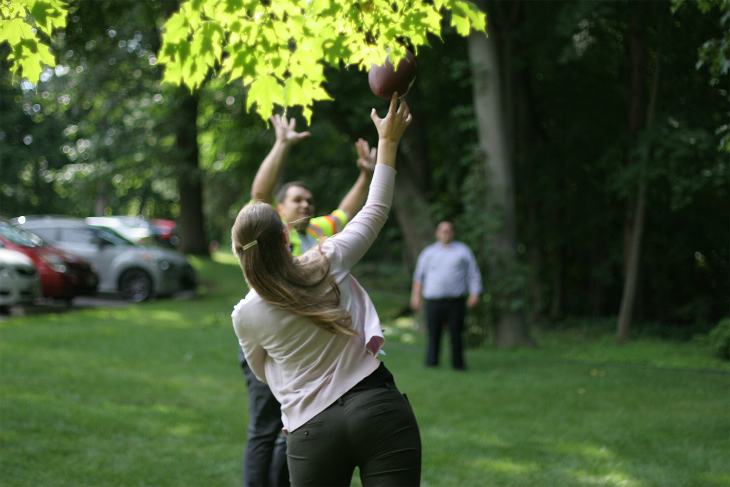 Joanne tosses the football over Val to Alan.