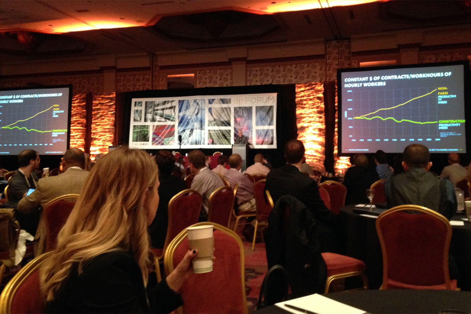 Man speaking from behind podium, in front of listeners at the conference.