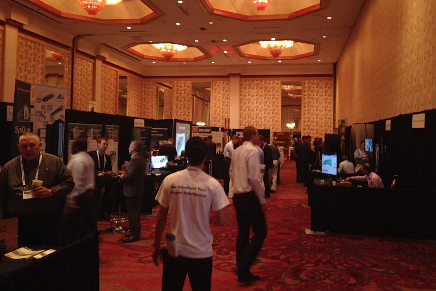 Some of the booths set up at the BIMForum. High walls with sconces. 
