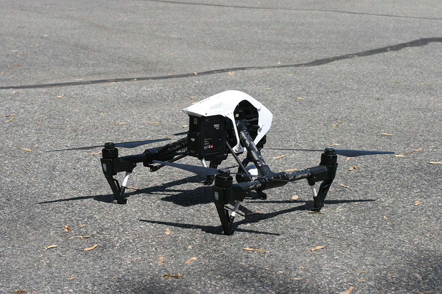 a drone laying on pavement 