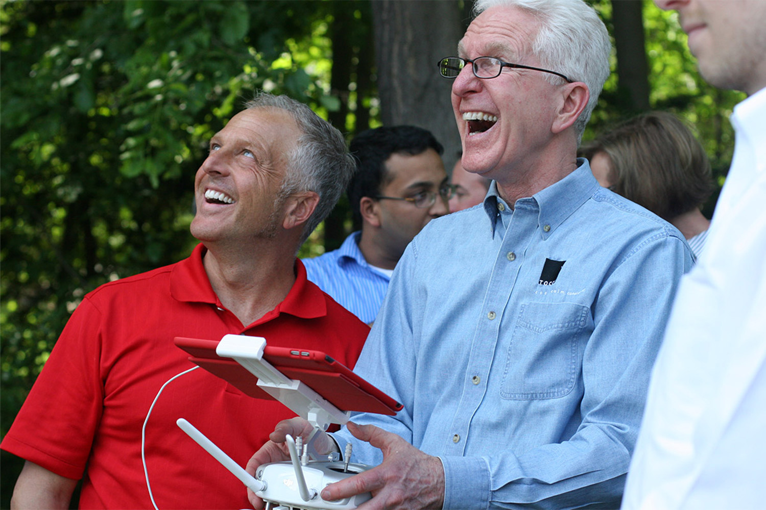 John and Mike smile as they use drone technology