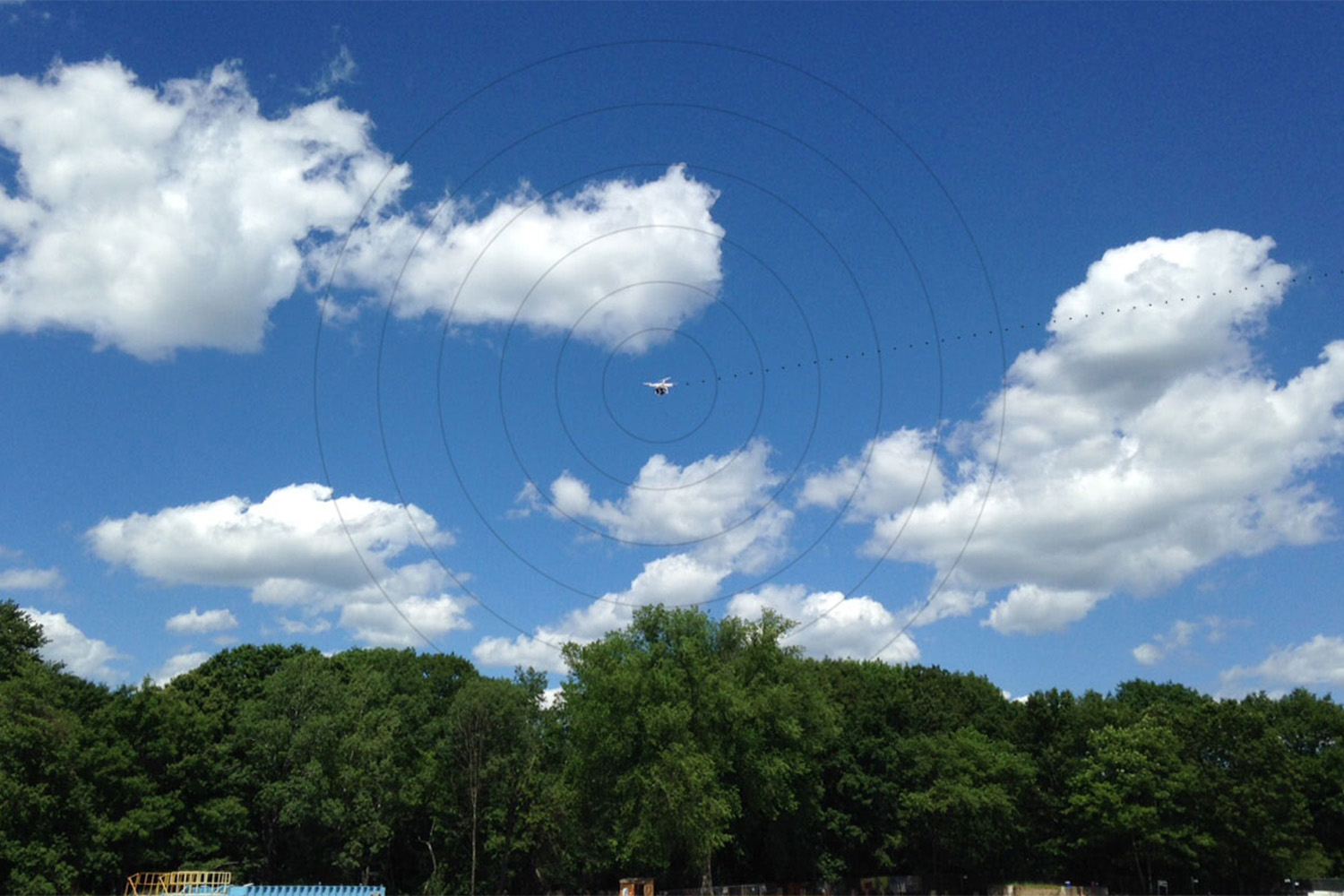 Drone with radius circled around it, as it navigates the air from a distance 