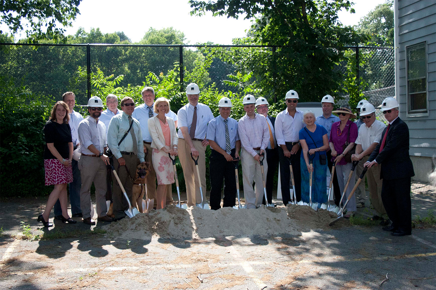 All groundbreaking ceremony participants holding shovels in the dirt pile 