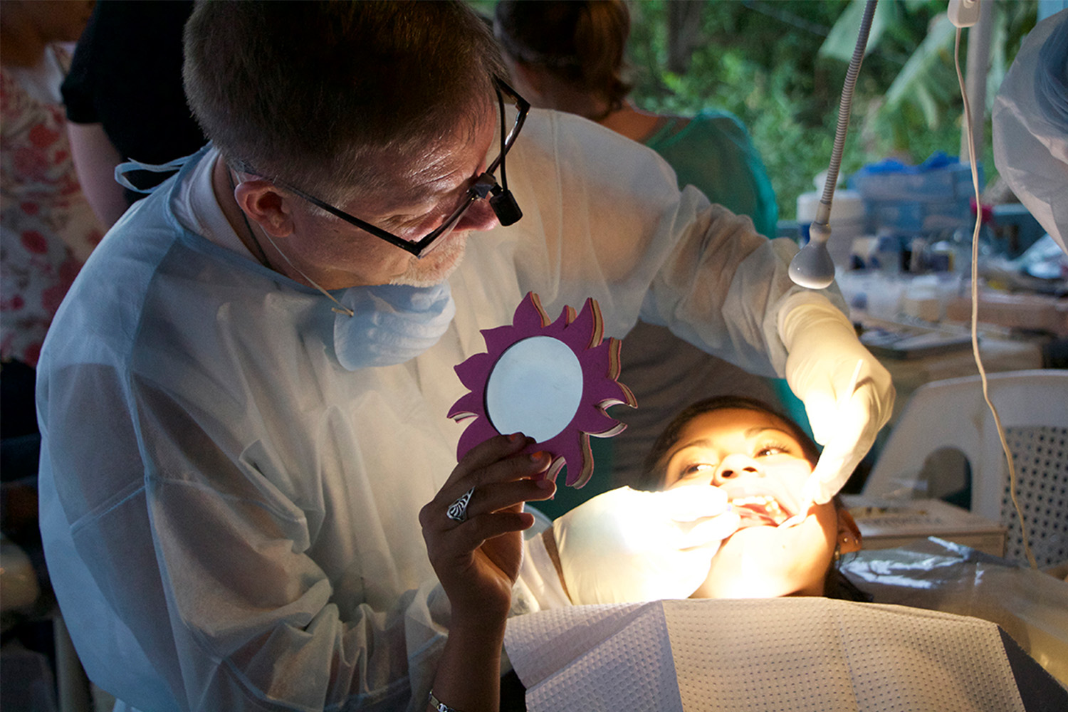 Dentist examining a girl's teeth