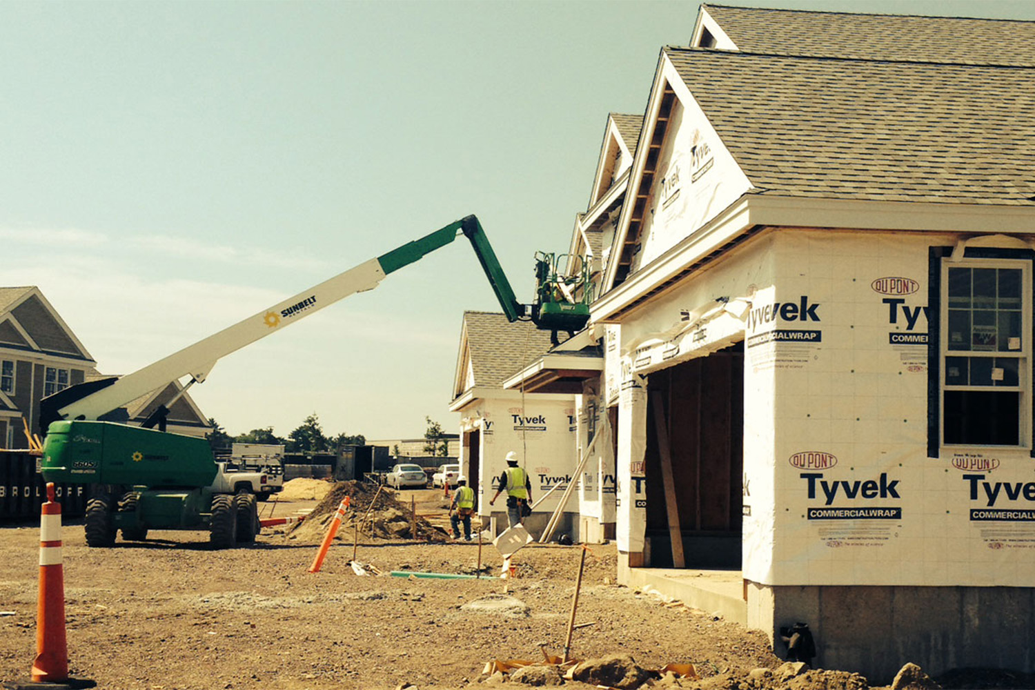 hydraulic crane next to a row of houses